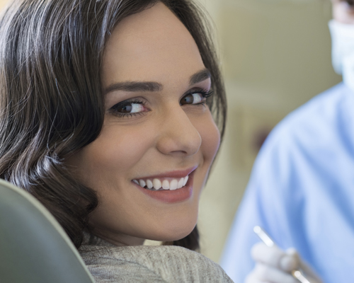 Smiling young woman receiving teeth whitening at Clapham dental practice