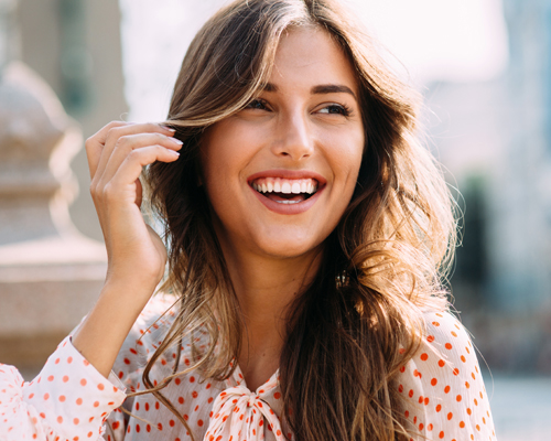 woman straightening teeth at Crescent Lodge Dental Practice in Clapham