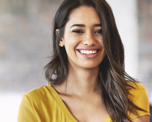 woman with adult braces in Clapham, London smiling at the camera