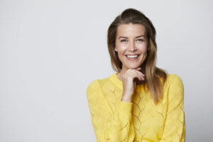 Woman wearing yellow top caring for dental implants