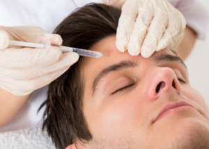 A woman injecting Botox into a mans forehead