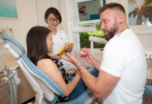 Dentist in Crescent Lodge Dental Practice talking to patient