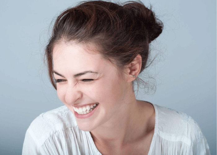 woman smiling after she replaced her white fillings that fell out