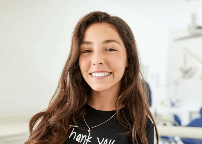 Woman smiling at the camera after having teeth whitening to fix her yellow teeth