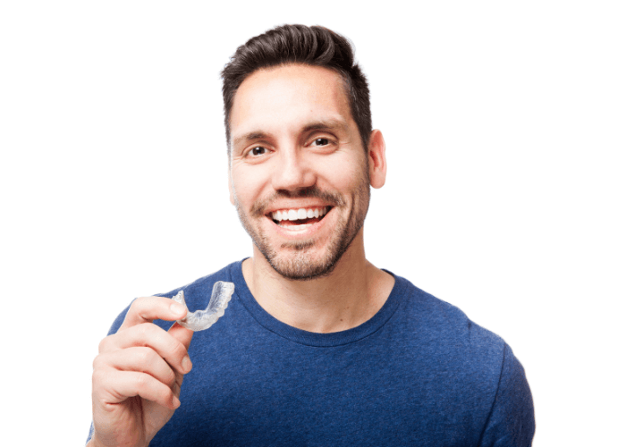 Man holding Invisalign braces whilst smiling